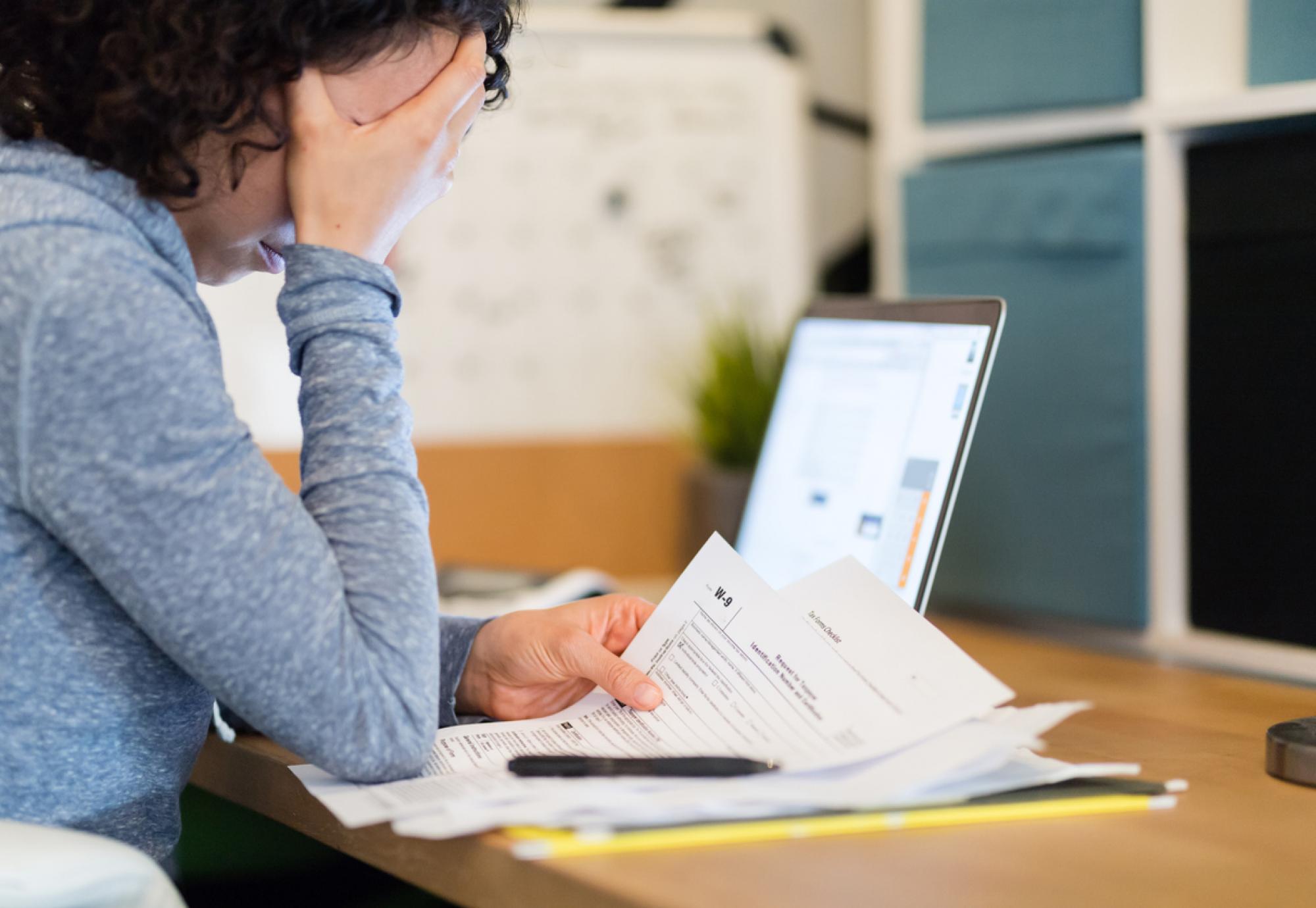 Woman looking at bills