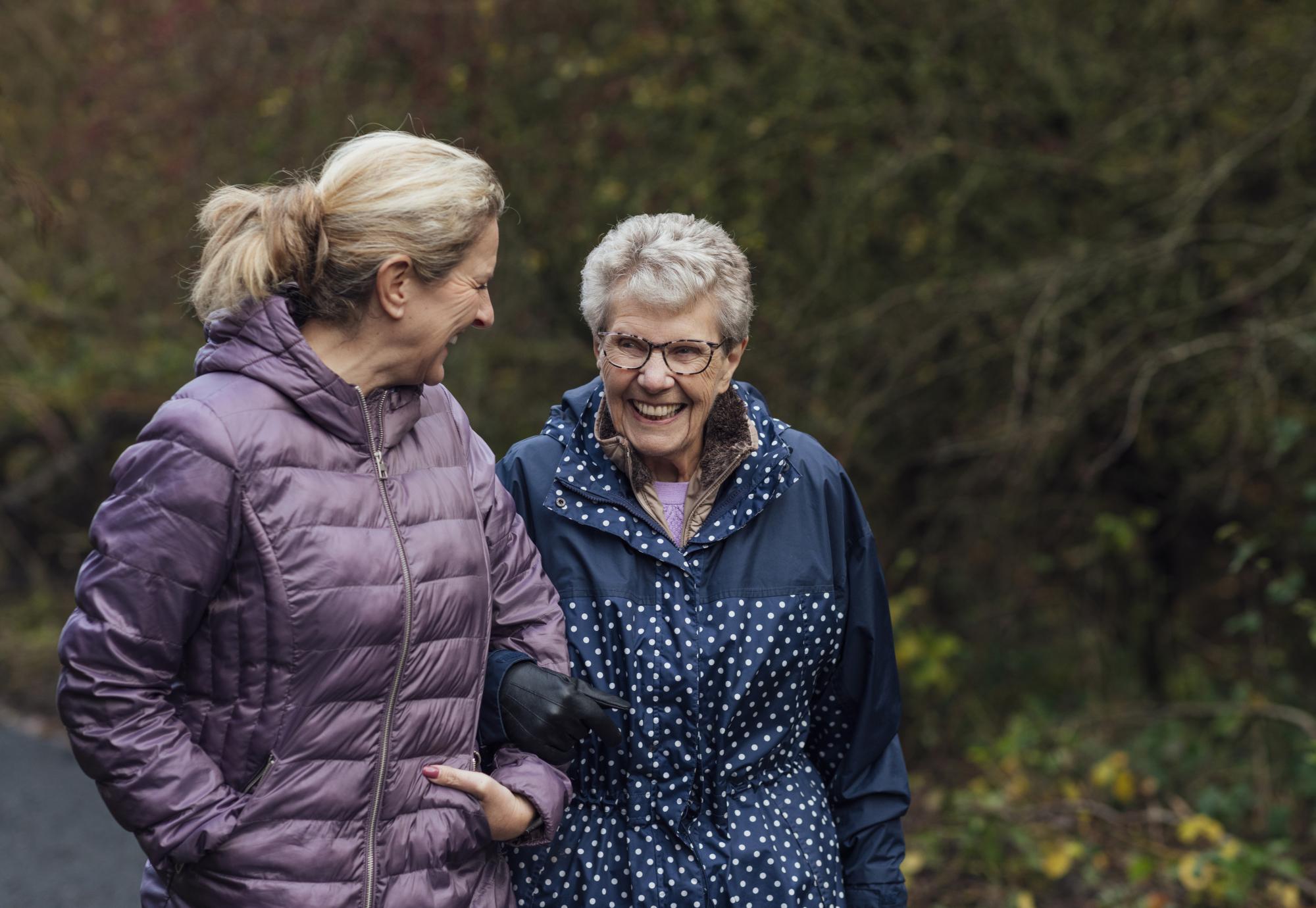 Senior woman on a walk with her carer