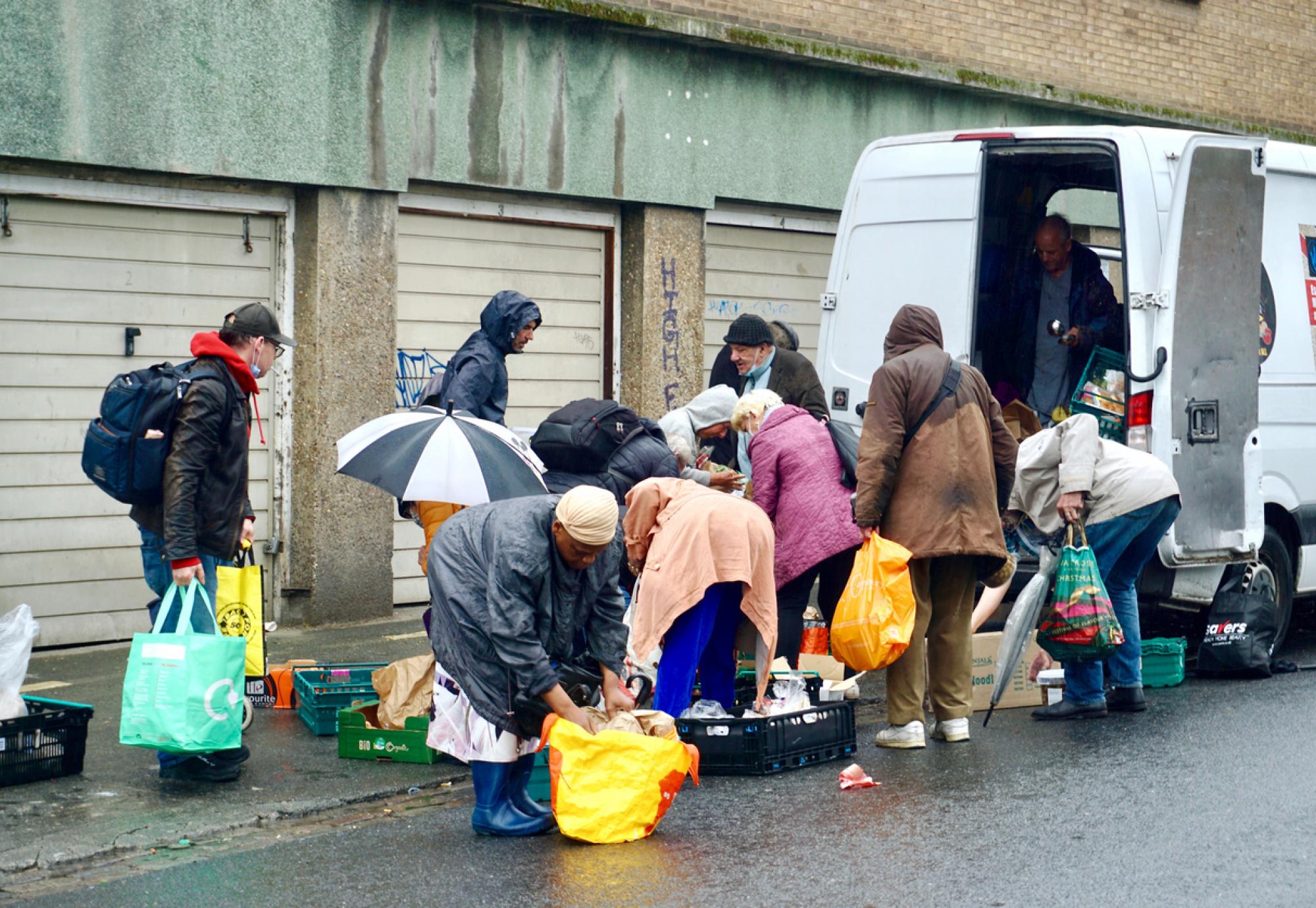 A charity food van distributes food to the vulnerable