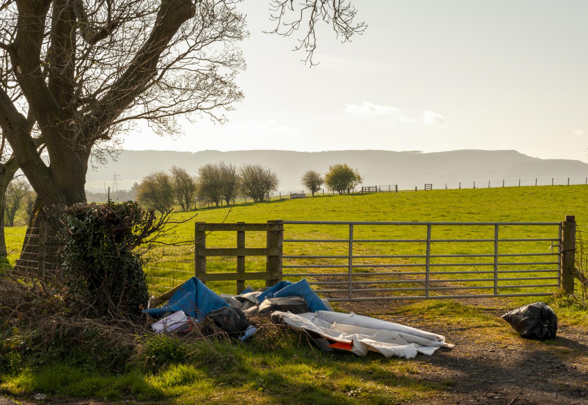 Illegal Fly Tipping by a Farmers Gate on a Quiet Rural Lane