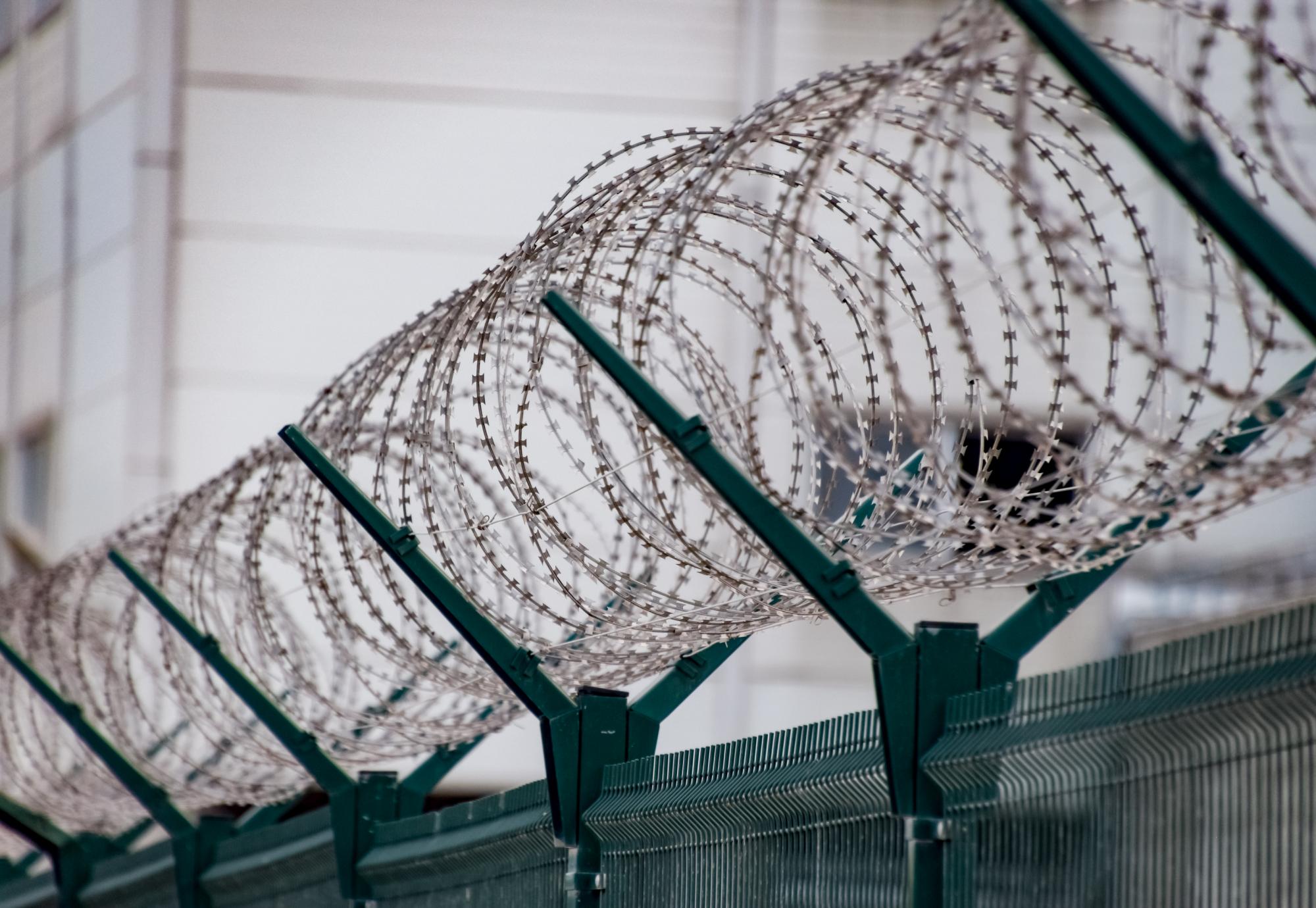 Barbed wire on the top of a prison fence