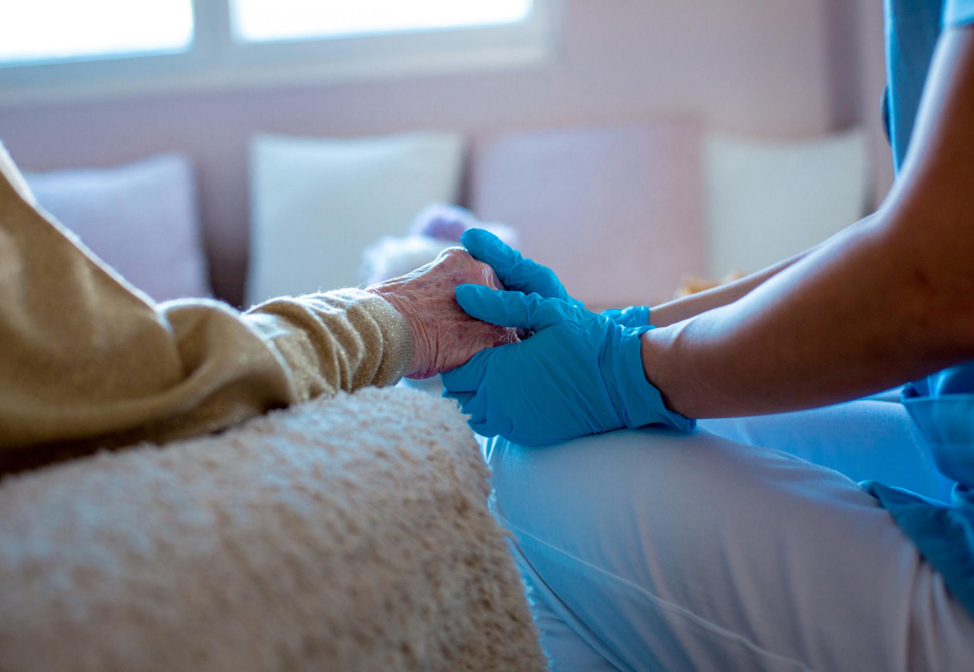 Nurse providing care at home for an older patient