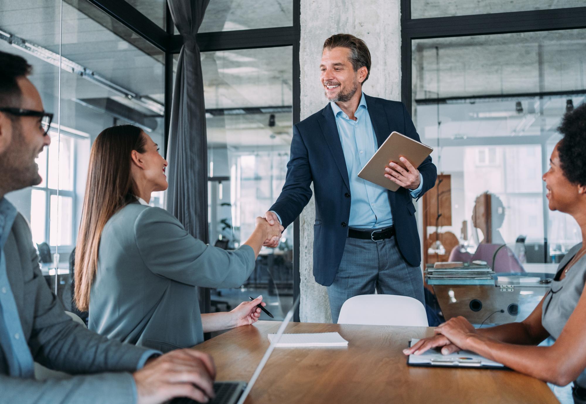 Businesswoman and businessman shaking hands