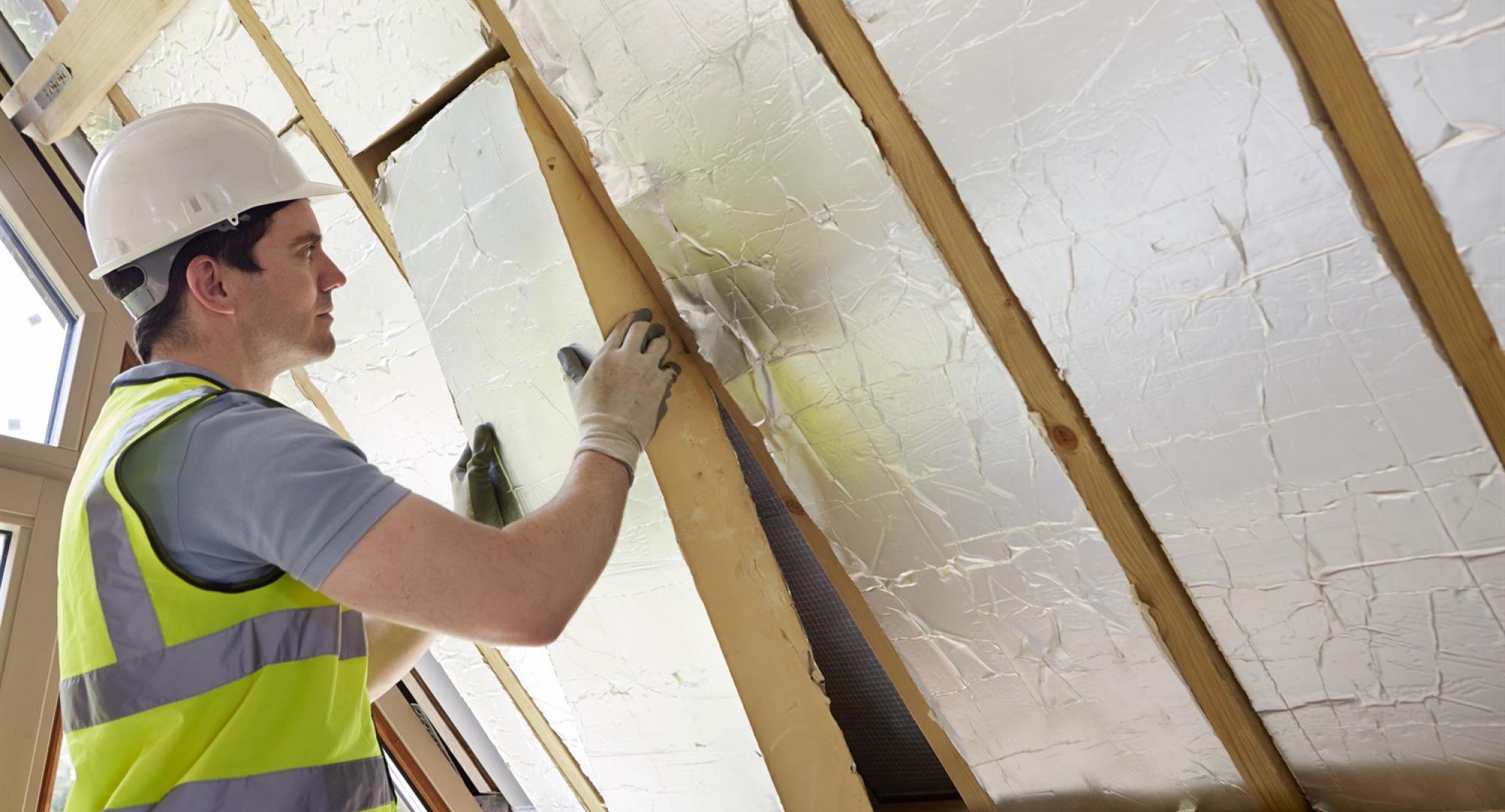 Insulation being fitted in a wall 