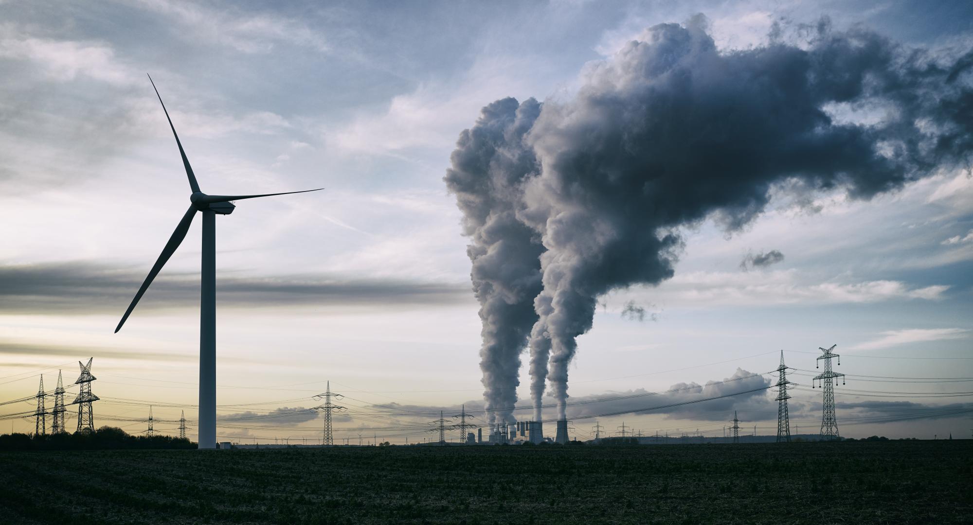 Cooling Towers next to wind turbines.