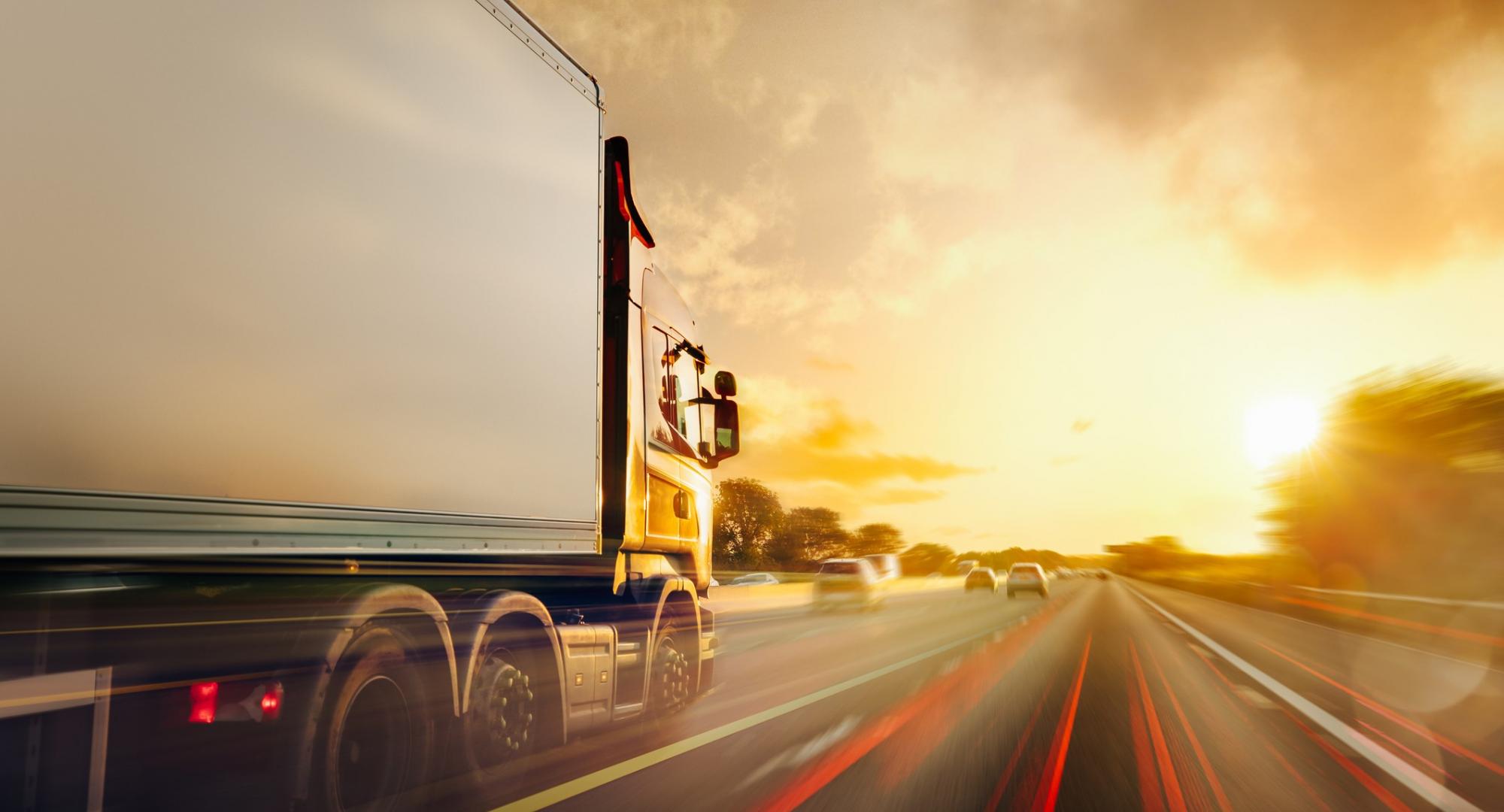 Lorry drives down the motorway with long exposure shot.