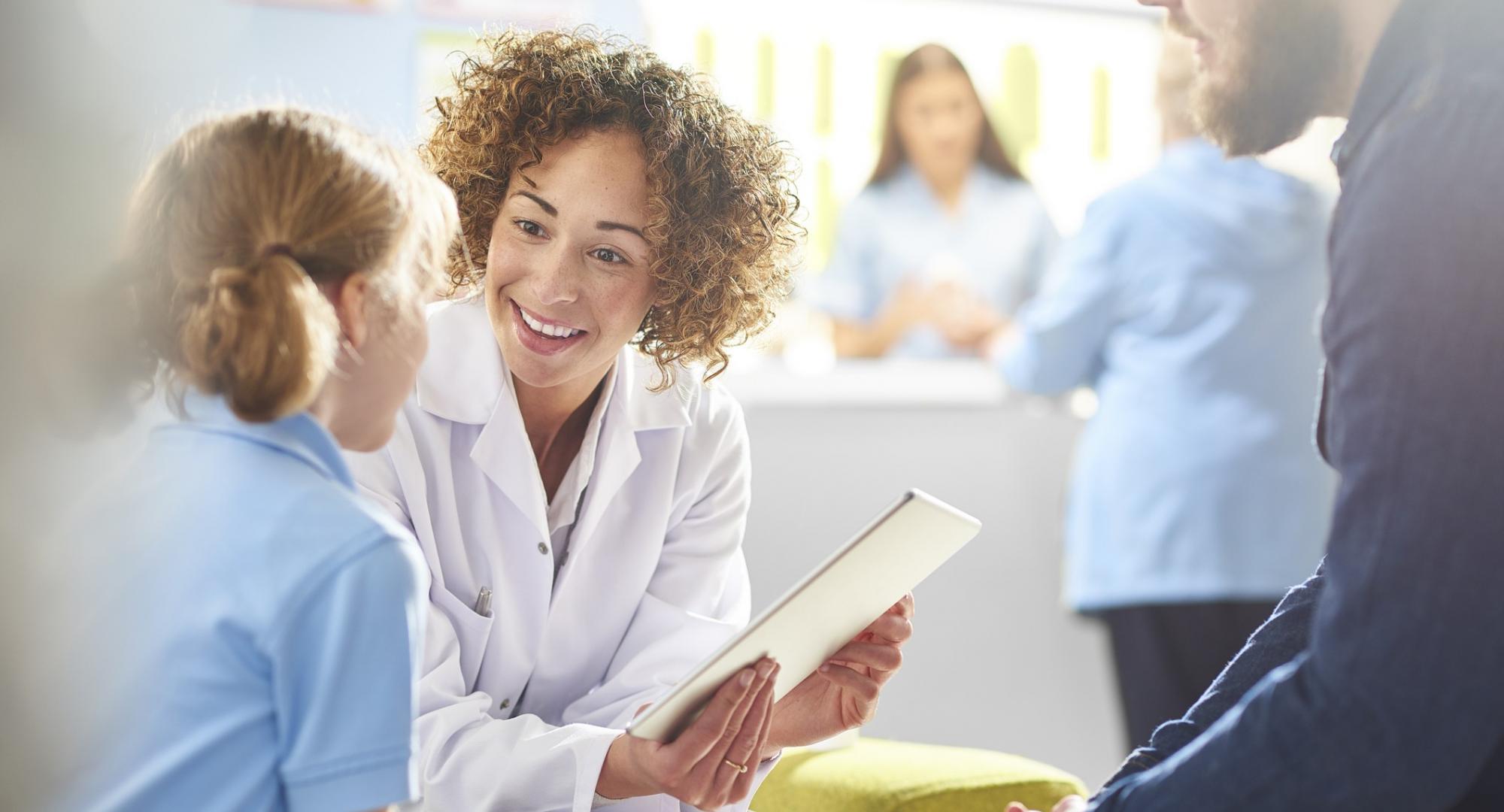 Female health professional talking with a young girl