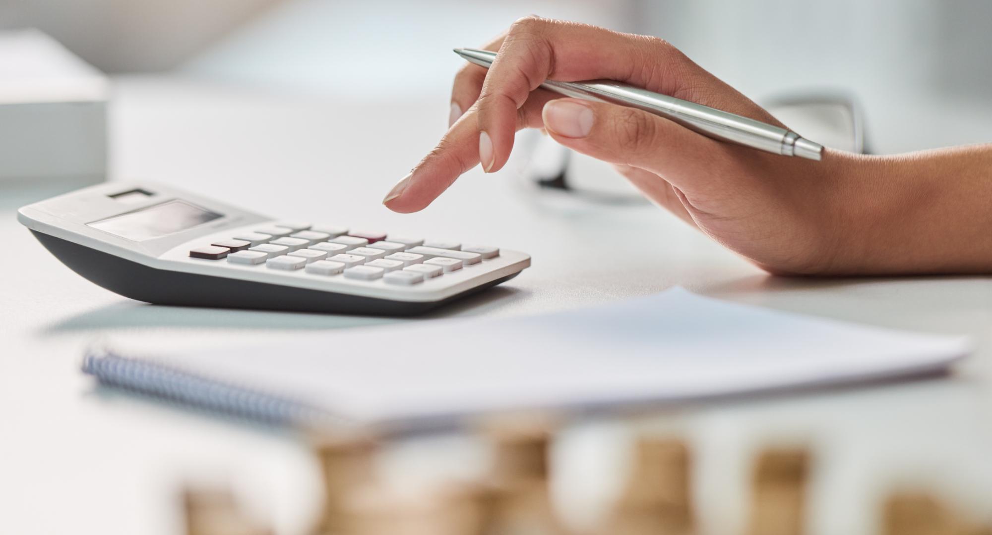 Woman uses calculator to work out her finances