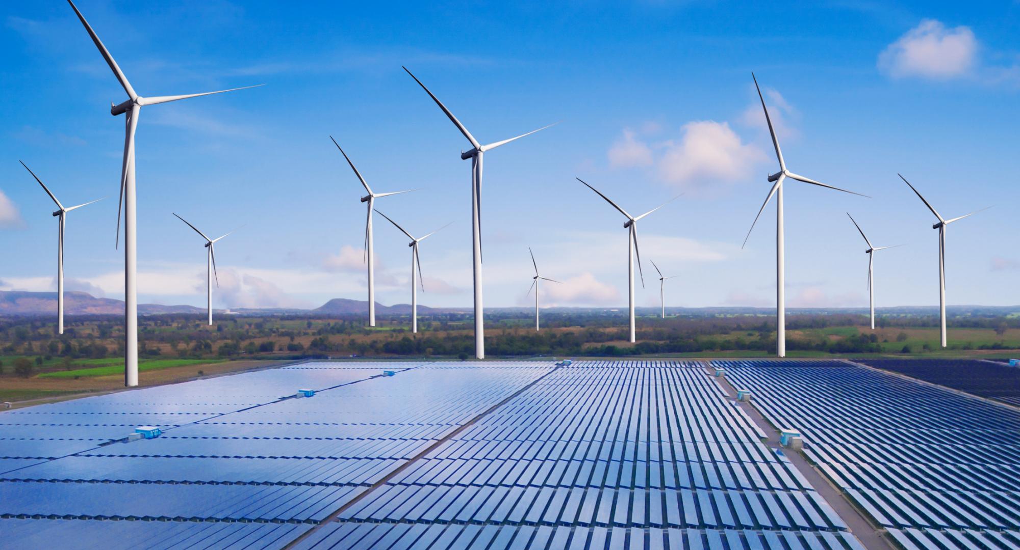 Solar plant with wind turbines in the background. 