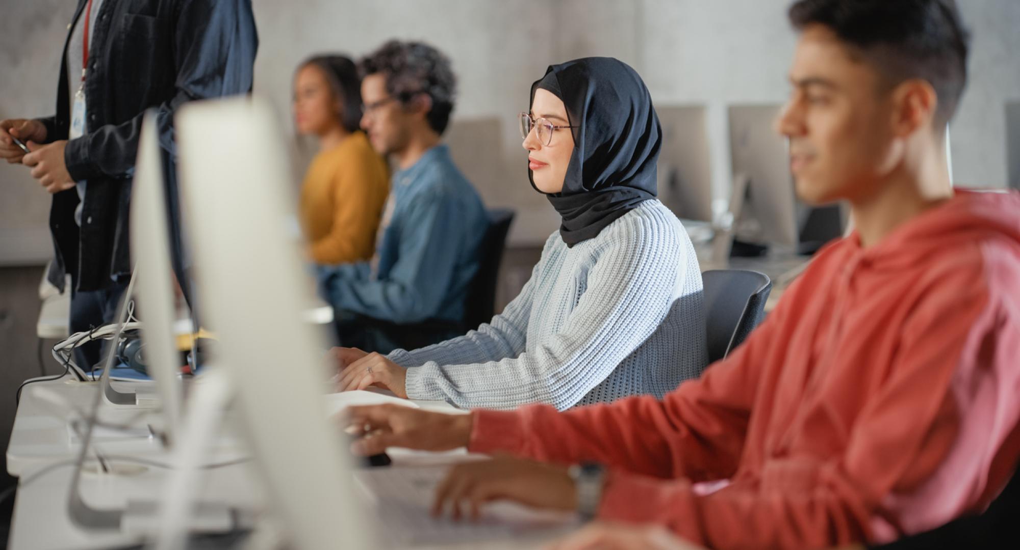 Adult learners working at computer