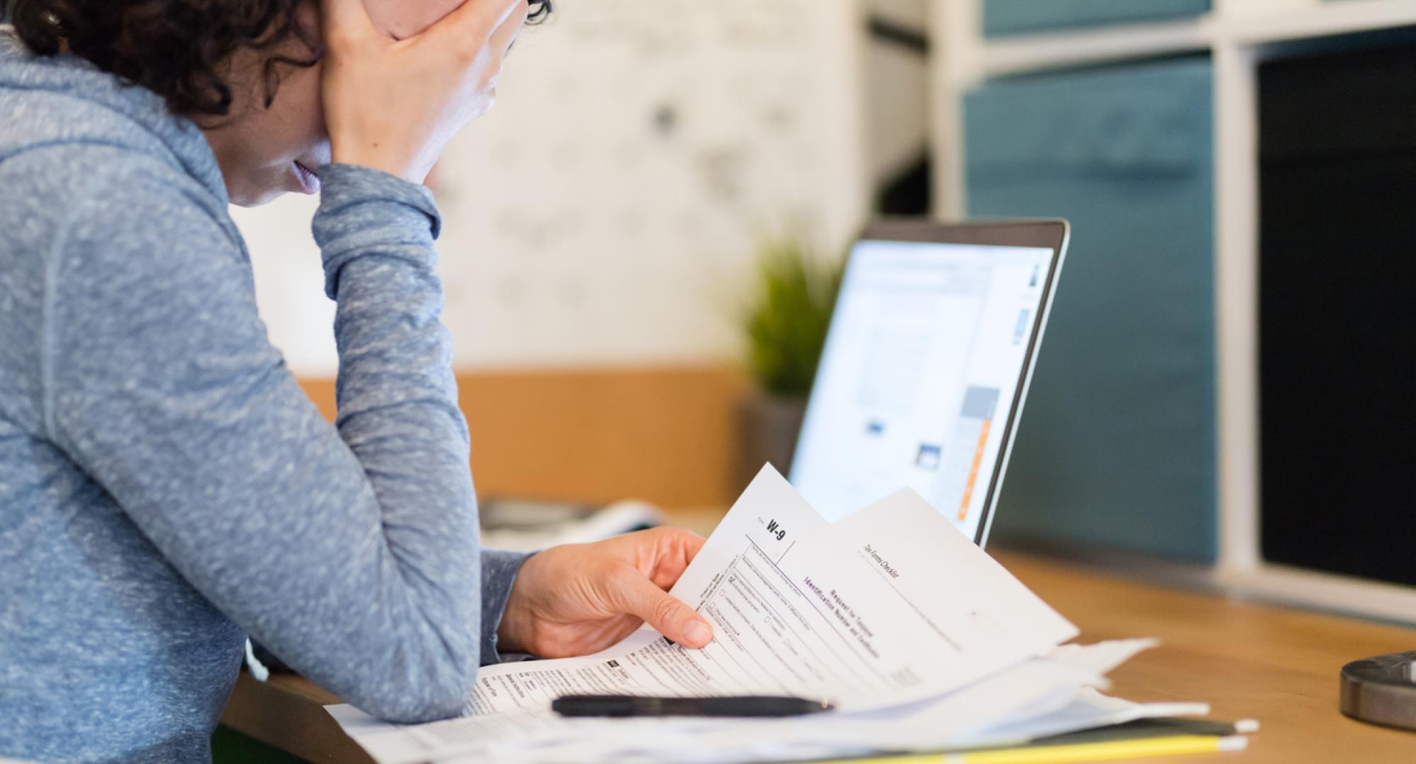 Woman looking at bills