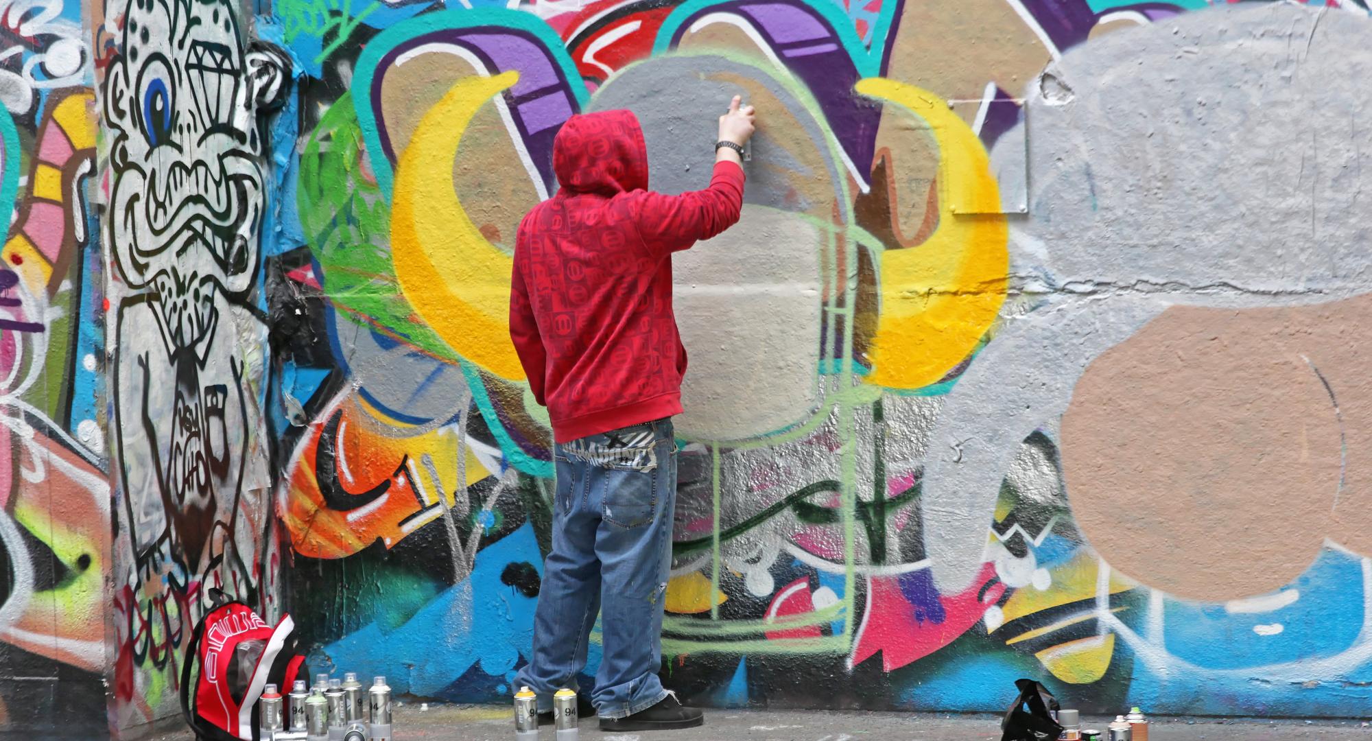 Man spray painting a well