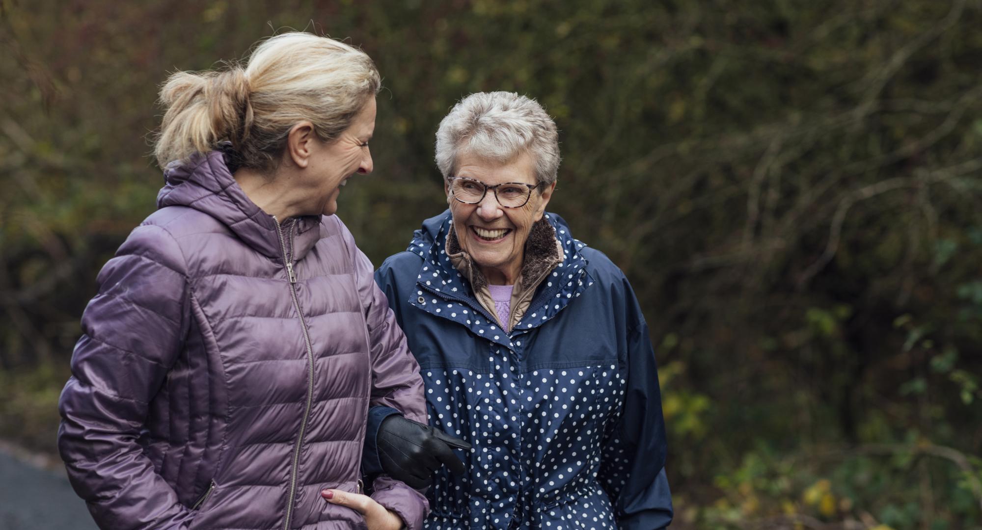 Senior woman on a walk with her carer