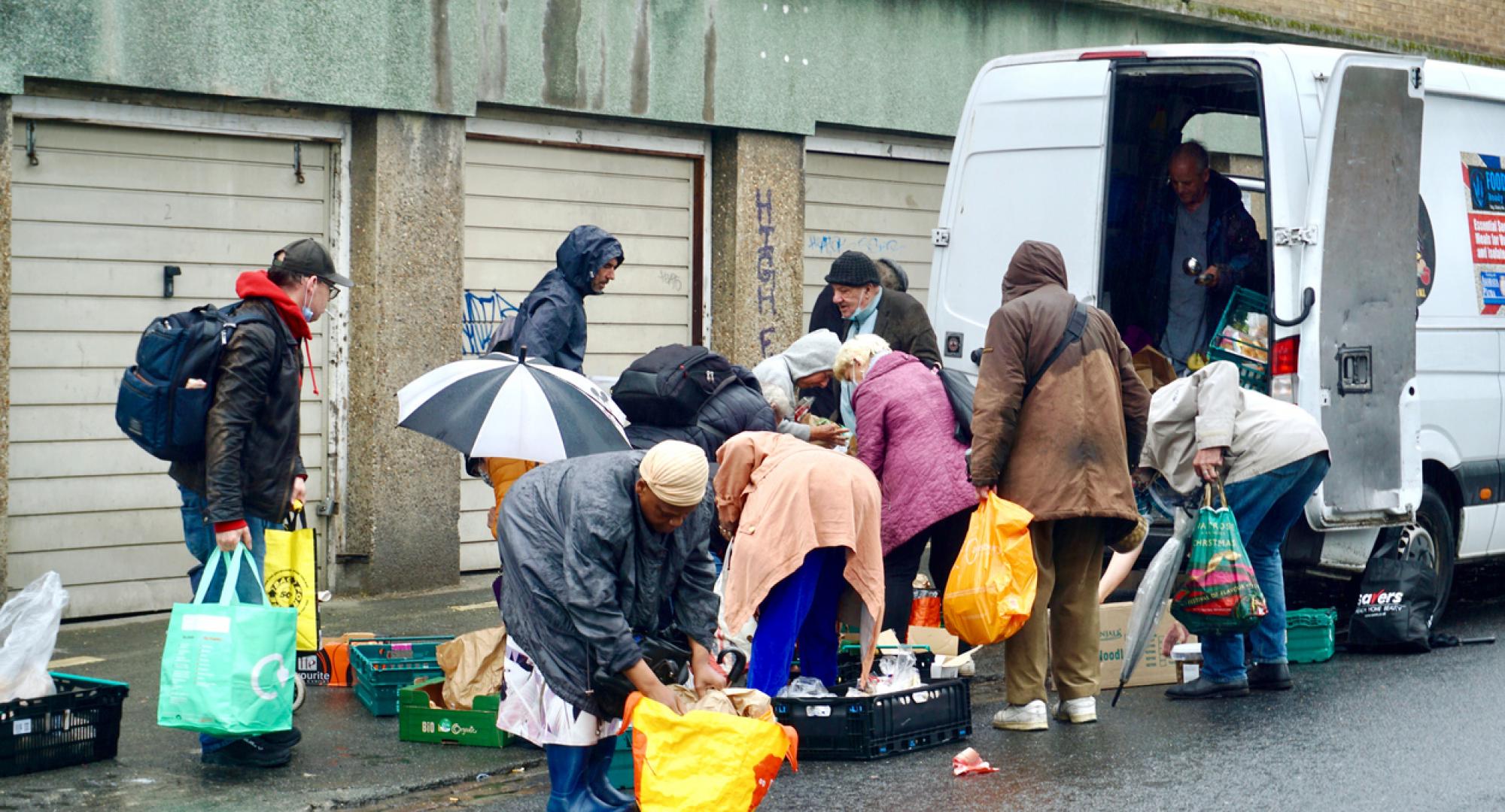 A charity food van distributes food to the vulnerable