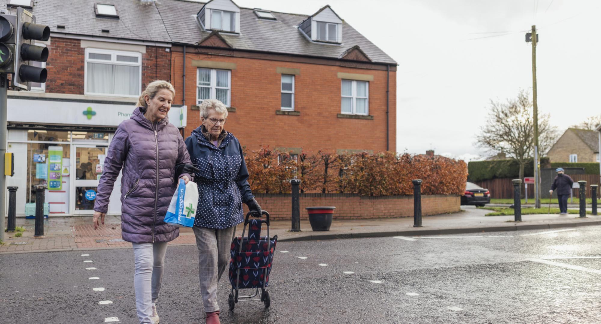 An elderly woman out with her unpaid carer