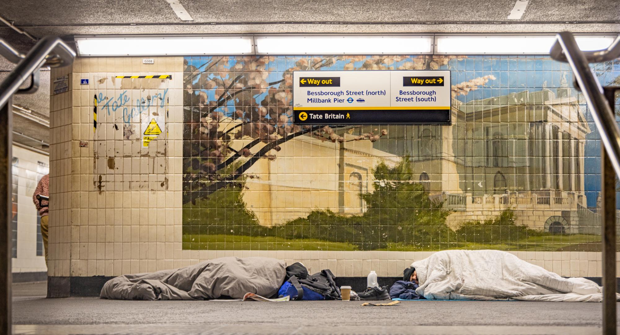 Homeless people sleeping in a London tube station