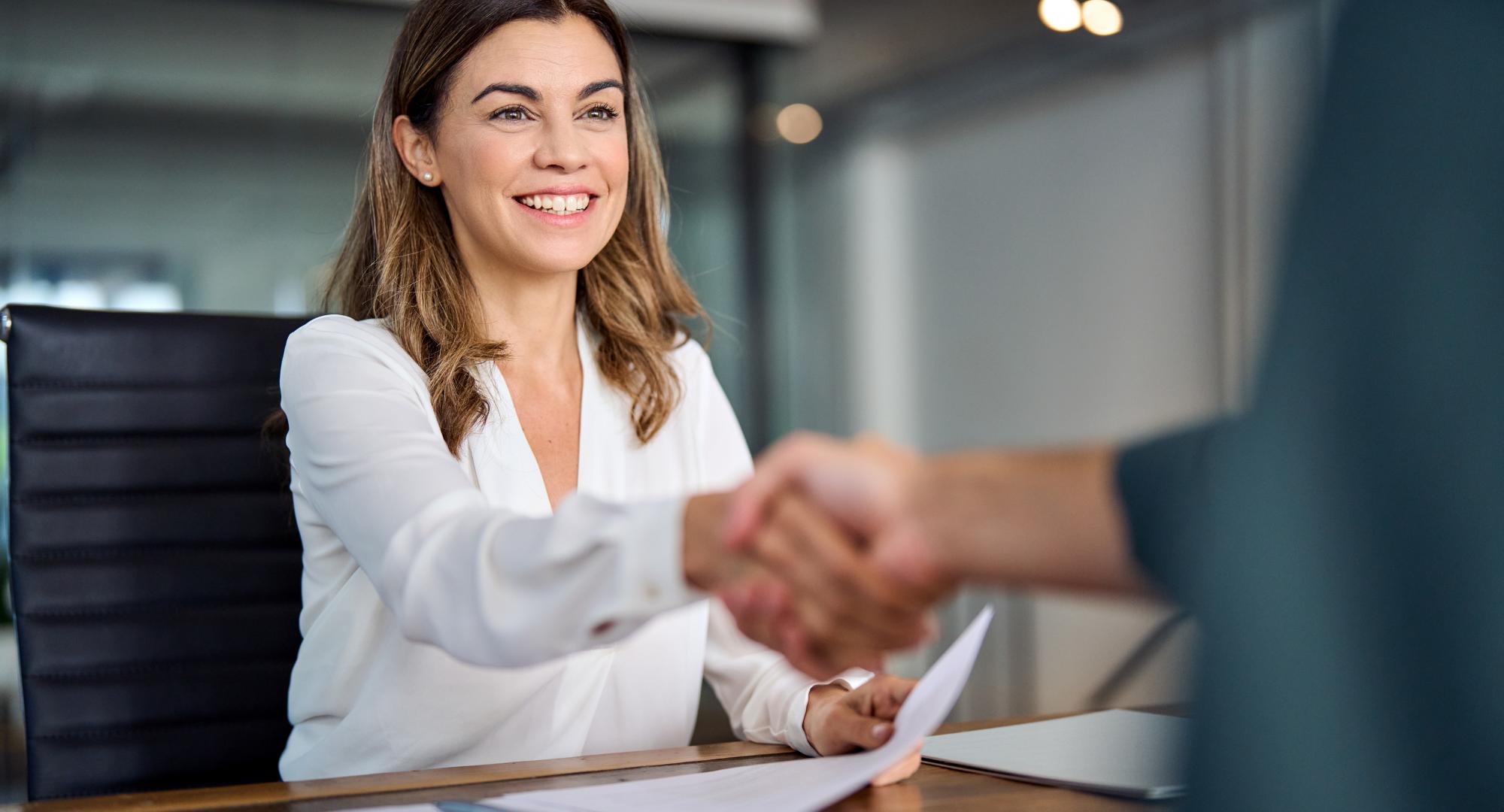 Public sector worker smiling and shaking hands