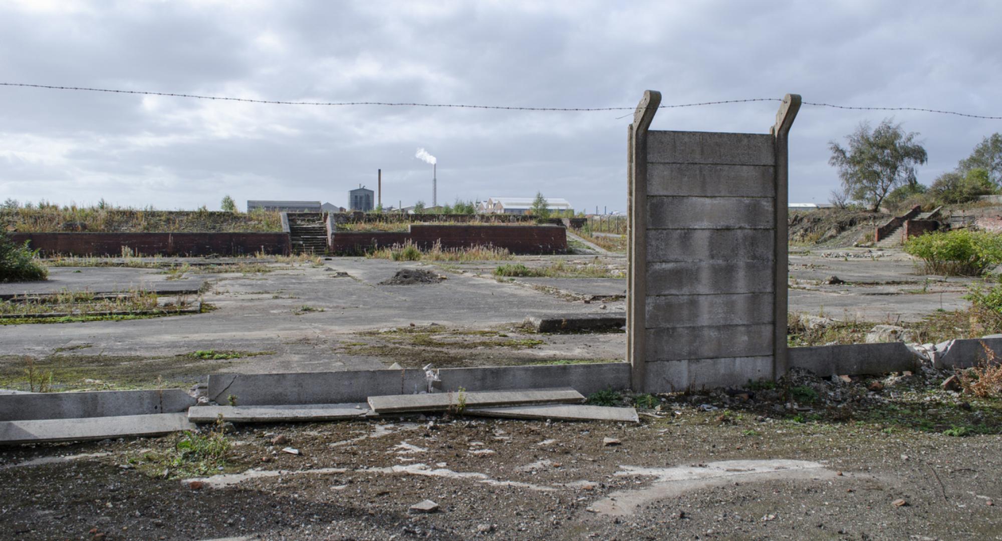 Brownfield land site with derelict wall