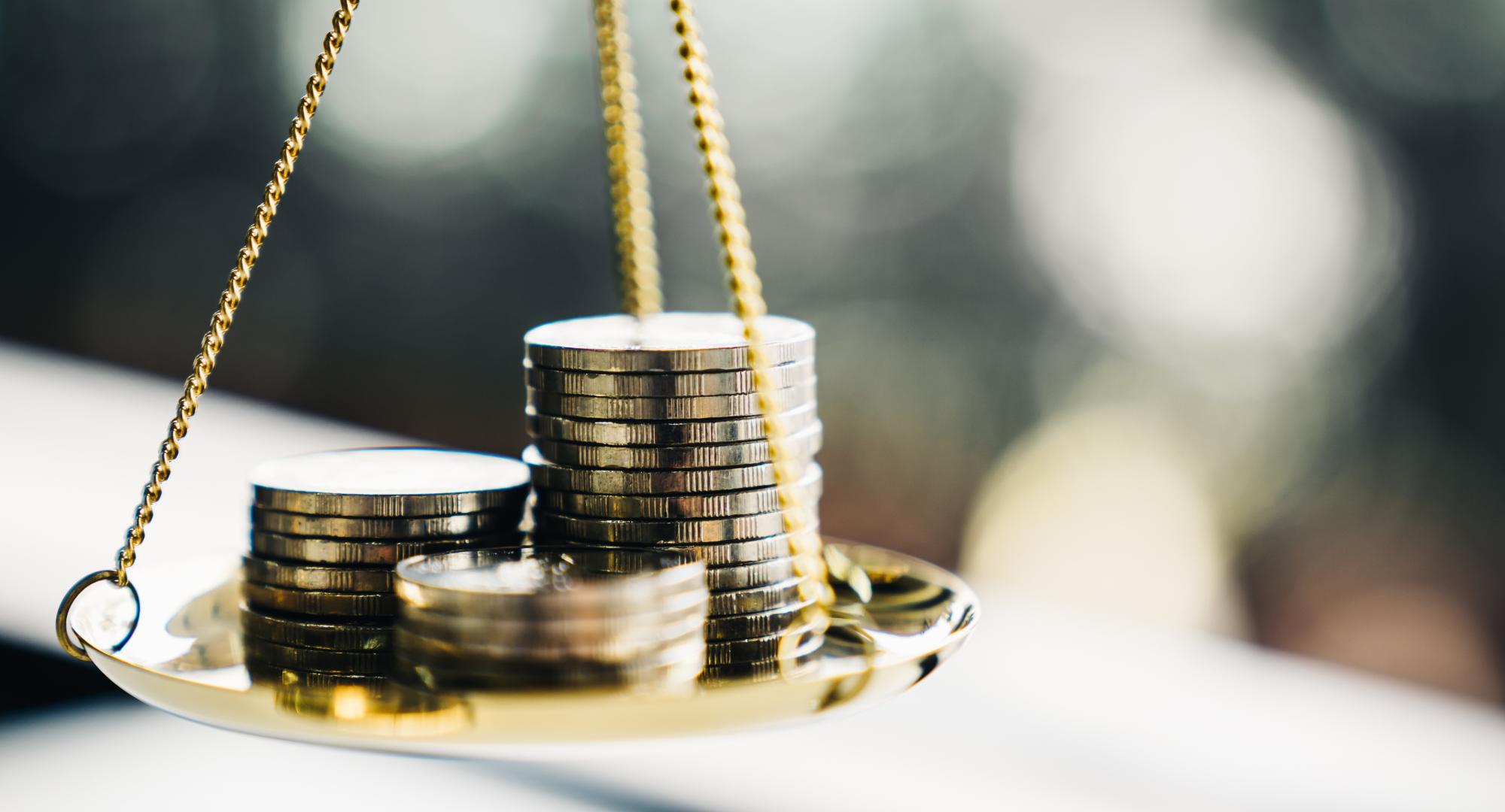 Coins balancing on a scale