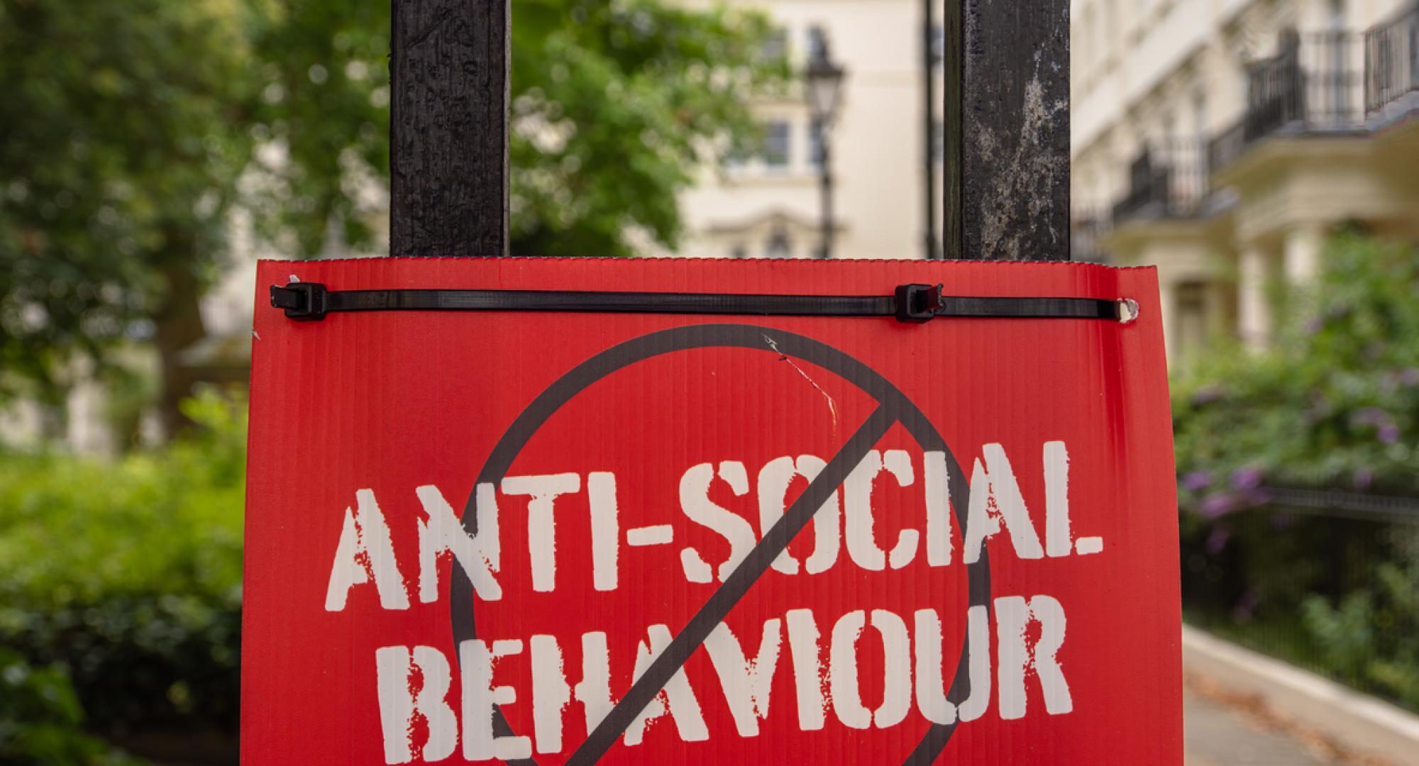 Sign with 'antisocial behaviour' crossed out