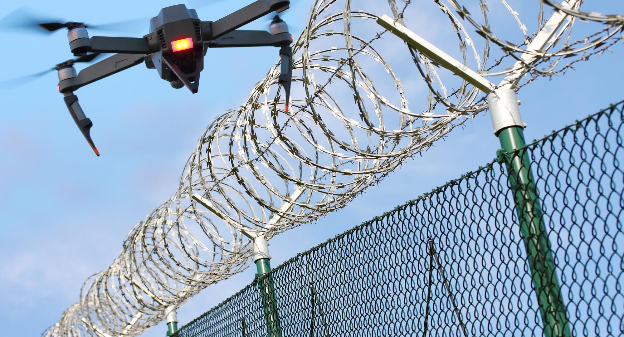 Drone flying over prison fence