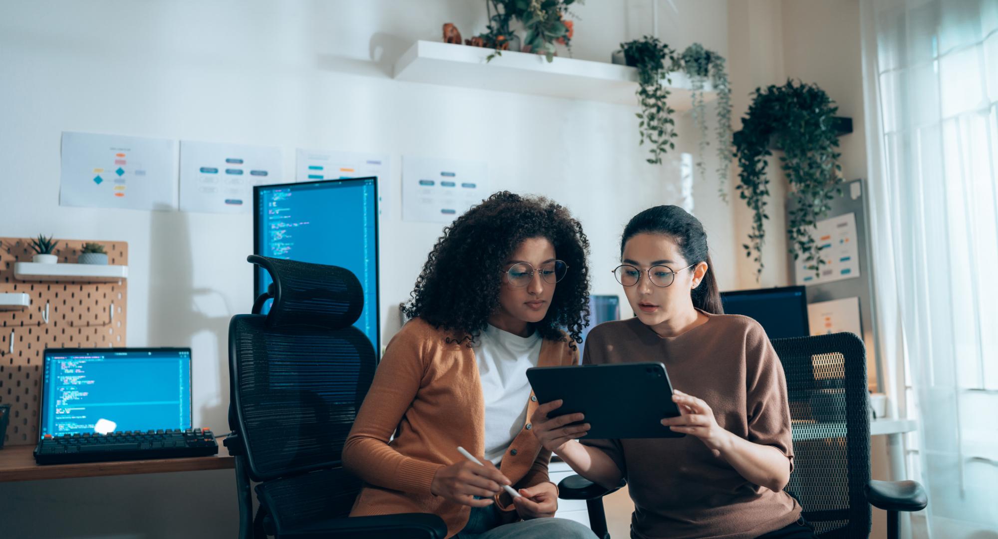 Two women working on computers