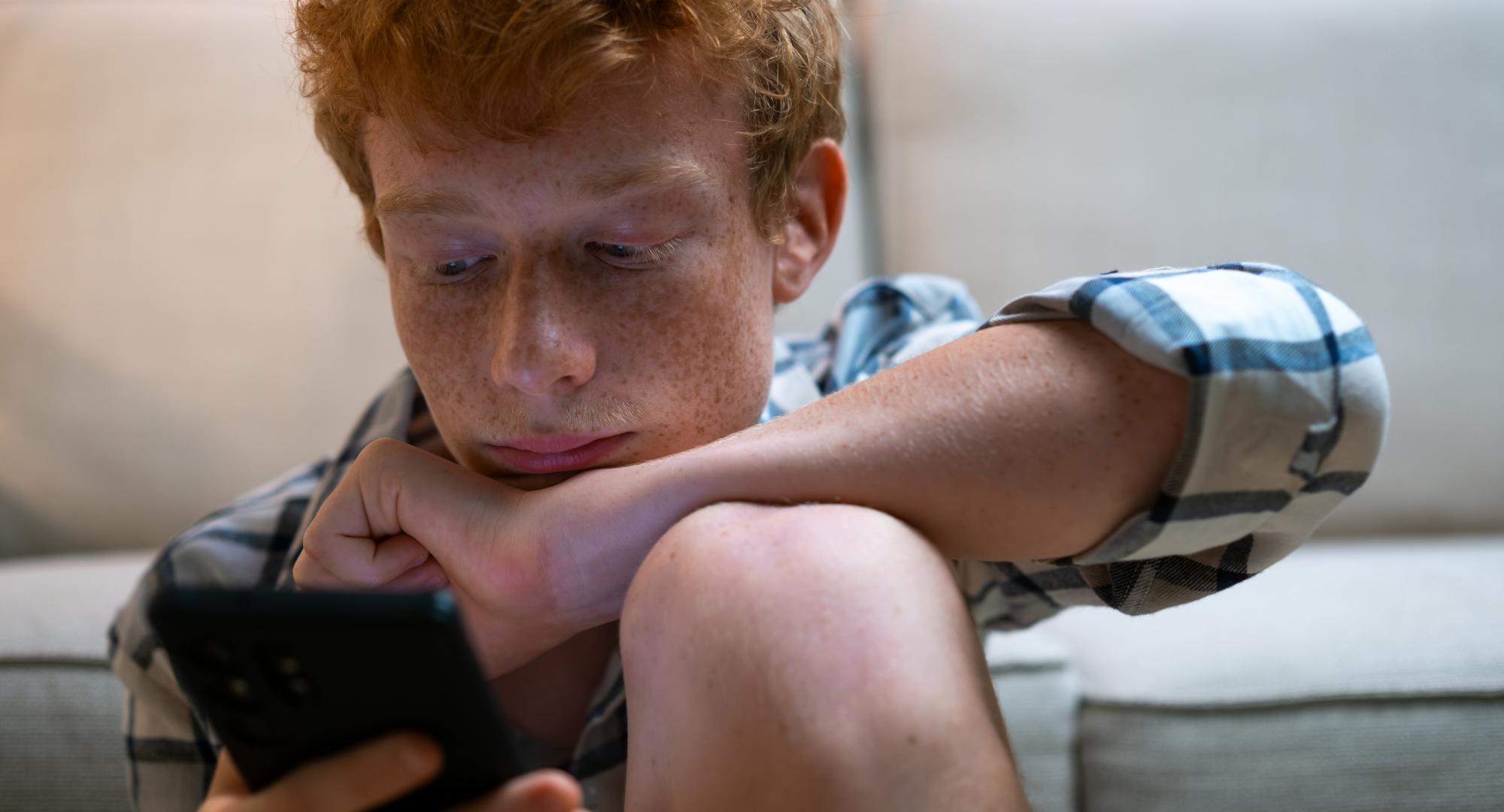 Teenage boy on his phone