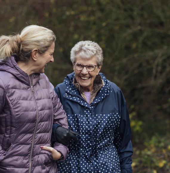 Senior woman on a walk with her carer