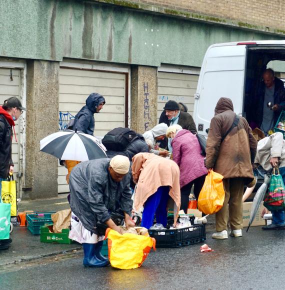 A charity food van distributes food to the vulnerable