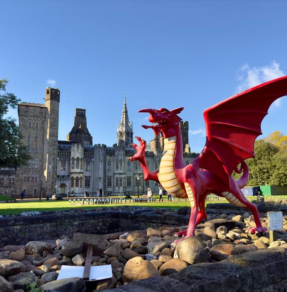 A red dragon in front of the Cardiff Castle