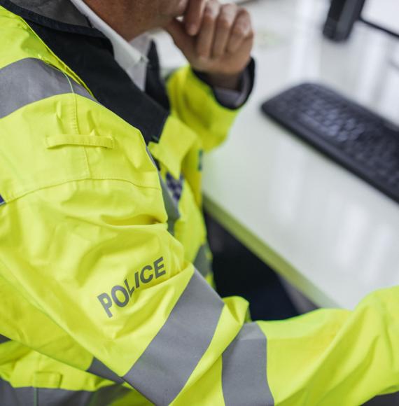 Police officer using digital system on a computer