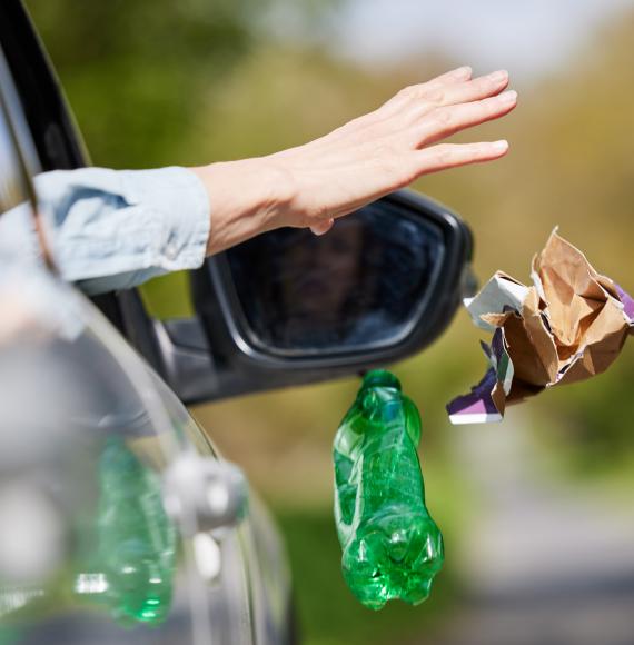 Person throwing rubbish from a car