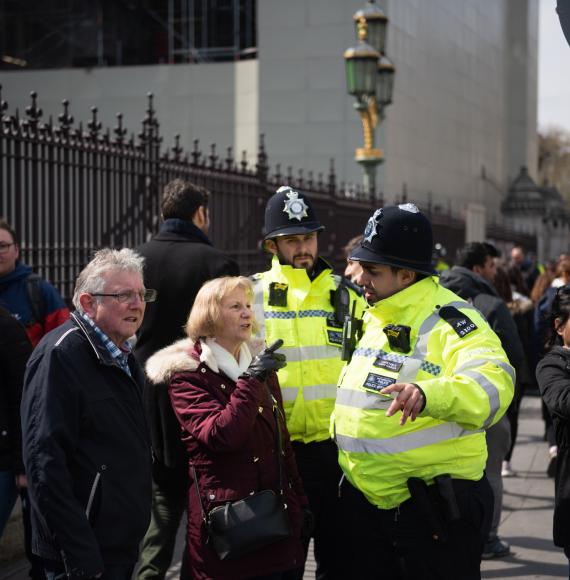 Two police officers helping people